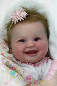 Close-up of lifelike reborn doll face with realistic skin texture and smiling expression