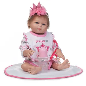 Detailed close-up of 48cm reborn doll with lifelike skin, lace outfit and pink accessories