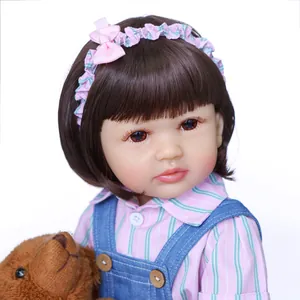 22 inch full body silicone reborn baby girl in pink stripes and blue denim overalls