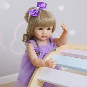 55cm lifelike silicone baby doll with long blonde hair and purple lace dress in a room