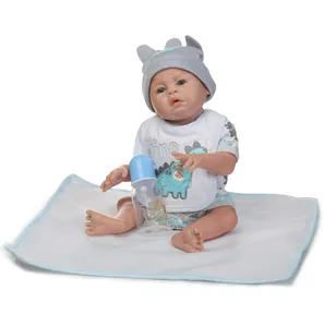 Detailed view of 48cm reborn doll with dino bib, knit hat, bottle and pacifier accessories