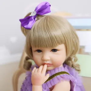 55cm realistic reborn baby doll with blonde curls and purple dress for bath time