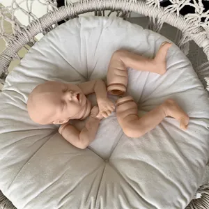 Unpainted 18-inch Twin A reborn doll kit with vinyl head and limbs on a white cushion