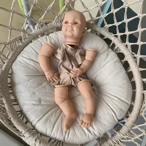 22 inch reborn doll kit with soft vinyl limbs and khaki fabric body on a cushion