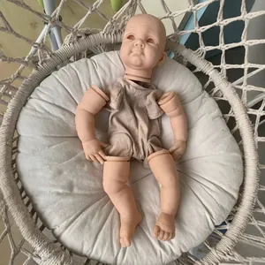 22-inch DIY reborn doll kit including head, limbs, and fabric body in a woven cradle