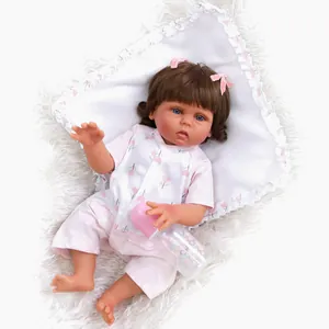 Close-up of lifelike 47cm reborn baby girl doll with pink bow and feeding bottle