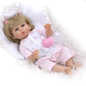 Detailed view of reborn baby doll in pink cherry outfit with a toy feeding bottle