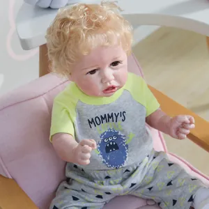 Realistic reborn toddler boy doll with blonde curly hair in yellow and grey baby outfit