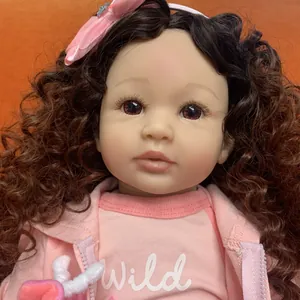 Lifelike 60cm reborn toddler doll with curly brown hair and pink hooded jacket outfit