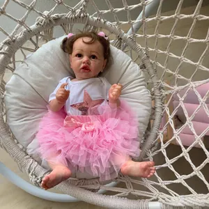 55cm Saskia reborn toddler doll in pink tutu dress sitting on a white hanging chair