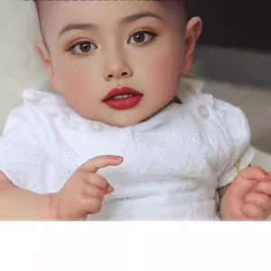 Lifelike 22-inch reborn baby girl doll in white embroidered lace outfit and makeup