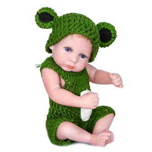 26cm realistic reborn baby doll wearing a green knitted frog costume on white background