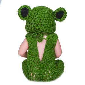 Close-up of handmade green crochet frog newborn photography outfit with back tie design