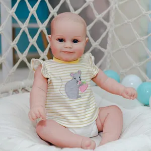 Realistic 20 inch Reborn Maddie doll wearing yellow striped shirt on white background