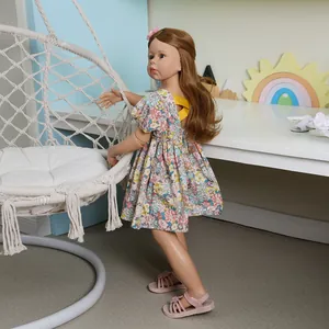 Lifelike 98cm masterpiece doll with long brown hair wearing a floral dress and pink sandals
