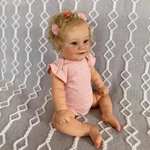 Realistic 60cm toddler girl doll with blonde curls and pink floral headband in sitting pose