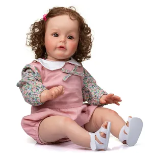 Realistic 60cm reborn baby doll with brown curls and pink floral Peter Pan collar dress