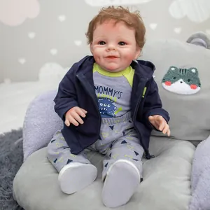 55cm lifelike reborn baby boy doll with brown curly hair in blue hoodie and grey trousers