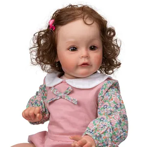 Close-up of 60cm reborn princess doll with curly brown hair and pink floral dress