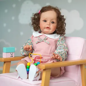 Realistic 60cm Sue-Sue princess doll with curly hair sitting on a pink sofa
