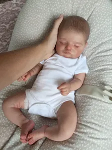 Detailed close-up of 48cm lifelike Reborn doll with realistic skin texture and closed eyes