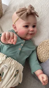 Detailed close-up of 60cm lifelike reborn doll wearing a sage green button shirt