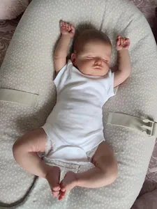 Detail of 48cm lifelike reborn baby doll Rosalie in white romper sleeping on a soft pillow