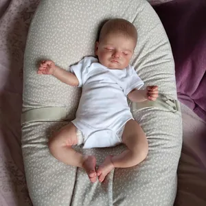 Lifelike 48cm Reborn baby doll Rosalie sleeping in white onesie on a floral nest