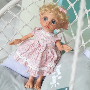 40cm fairy reborn doll with blonde curls and pink floral dress in a hanging chair