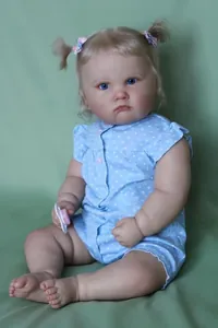 Detailed view of 60cm reborn baby doll with blonde hair and blue eyes in sit pose