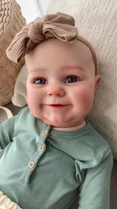 Close-up of 60cm reborn doll with sage green ribbed romper and wooden buttons detail