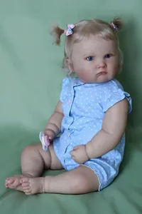Close-up of reborn baby doll Charlotte featuring realistic skin texture and blonde pigtails