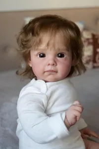 Close-up of a 60cm lifelike reborn doll showing realistic facial expressions and soft hair