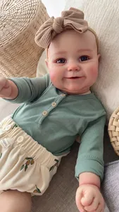 Detailed close-up of reborn toddler doll Maddie with realistic skin texture and clothing