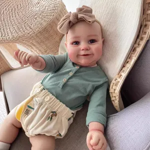 60CM lifelike reborn toddler doll in green top and olive leaf print bloomers in basket