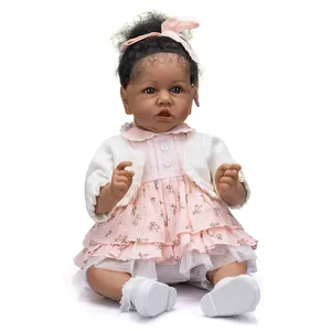 55cm lifelike reborn baby doll with dark skin wearing a pink floral dress and white cardigan