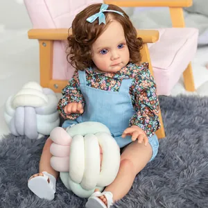 60cm realistic reborn baby doll Maggi with brown curly hair and blue floral outfit