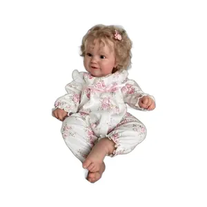 Realistic 60cm reborn baby doll with curly blonde hair and pink floral print outfit
