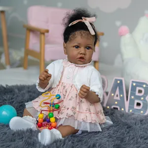 55cm African American Reborn Baby Doll Saskia in floral dress and pink bow headband