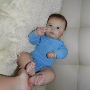 60cm realistic reborn toddler Joseph doll wearing a blue long sleeve onesie on plush mat