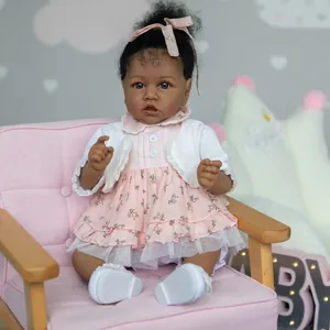 55cm African American Reborn doll Saskia in pink floral dress on a mini pink chair