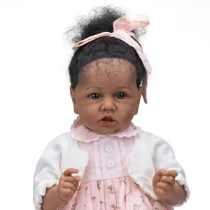 55cm Saskia reborn doll with dark skin tone, curly hair and pink floral dress
