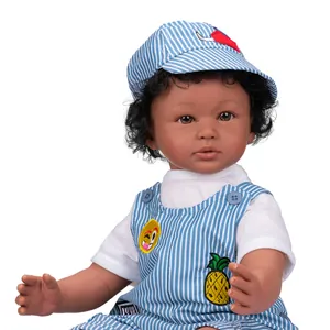 Realistic 60cm baby boy doll with dark skin tone wearing blue striped overall and hat