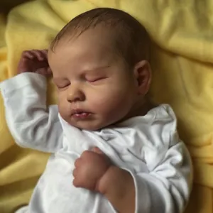 Close-up of realistic newborn reborn doll with detailed skin texture and sleeping face