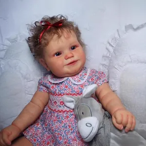 60cm Maddie reborn baby doll with brown hair, floral dress and plush donkey toy