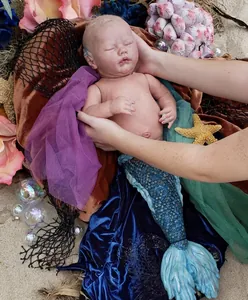 Realistic 25-inch mermaid reborn baby doll kit with blue scales and ocean scene props