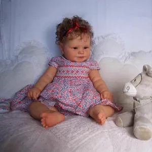 60cm Maddie realistic reborn toddler doll with curly brown hair and floral red dress