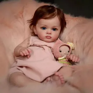 Realistic 60cm reborn toddler doll with curly brown hair and blue eyes in pink lace romper