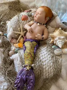 Macro shot of 25 inch lifelike mermaid reborn baby doll with scales and sea shell jewelry