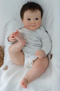 Macro shot of 60cm reborn baby doll with realistic 3D skin texture and gray romper